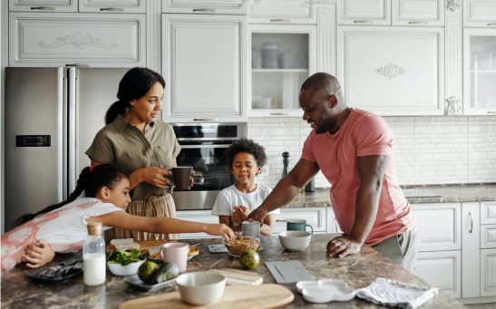 A family preparing food on a kitchen counter