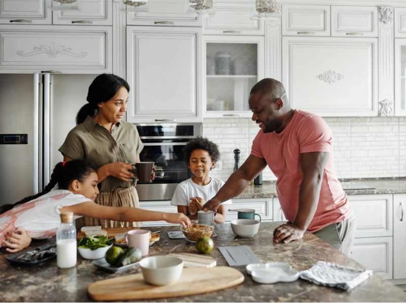 A family preparing food on a kitchen counter