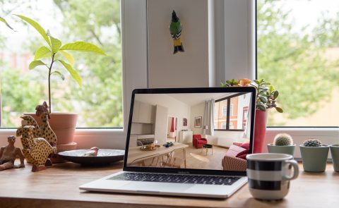 A laptop showing an image of a home interior