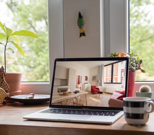 A laptop showing an image of a home interior