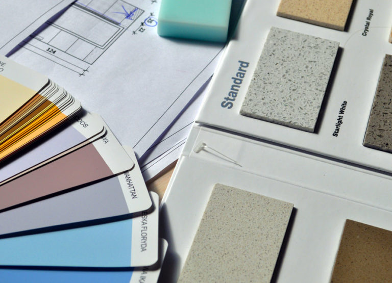 Paint and countertop swatches spread out on a table